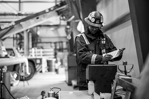Field technician performing high velocity oil flushing service on turbine